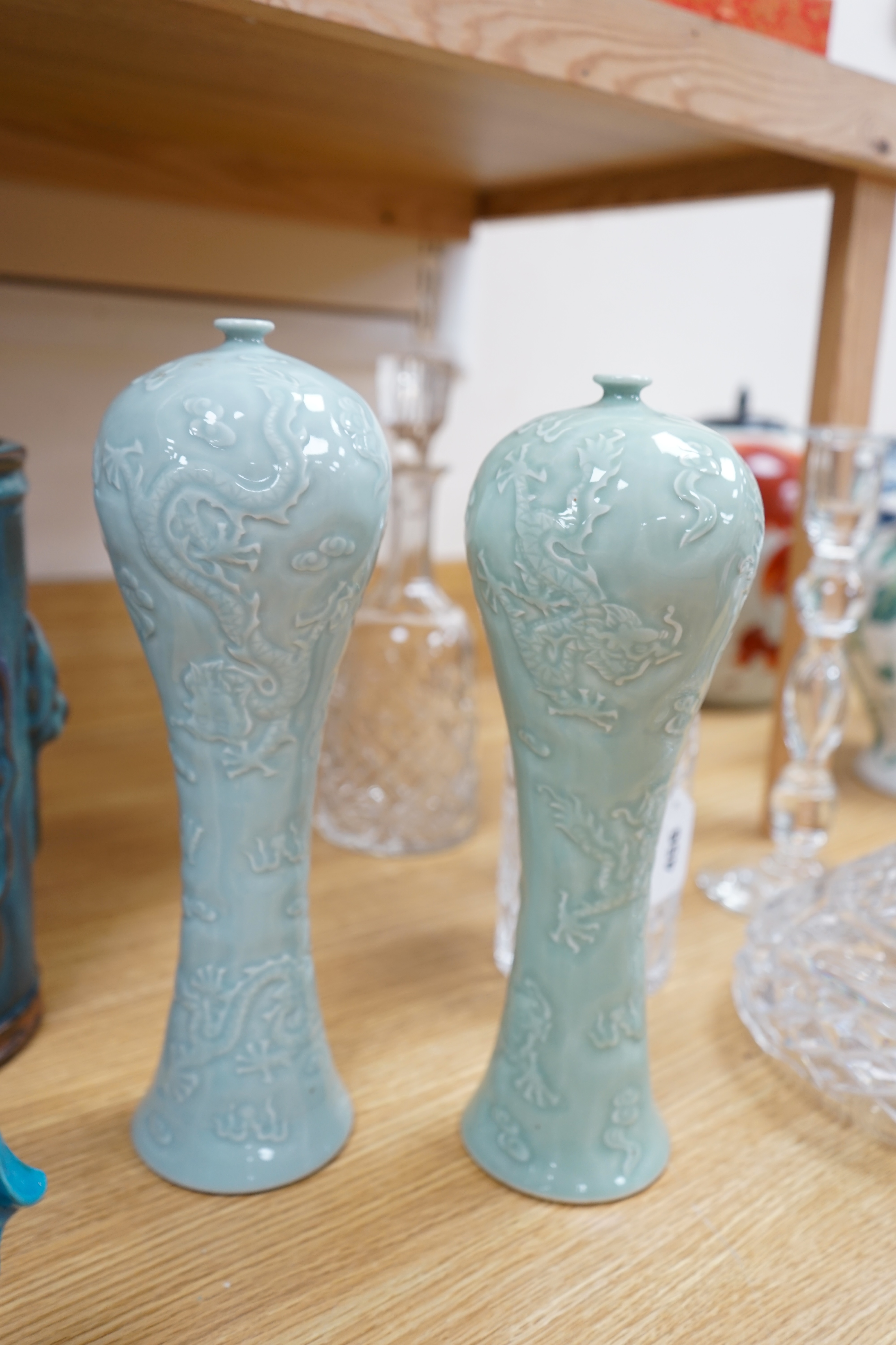 Eight pieces of Chinese porcelain to include a pair of temple dogs, a pair of relief moulded celadon glazed vases and a pair of Sang de Boeuf vases, largest 31cm high. Condition - good